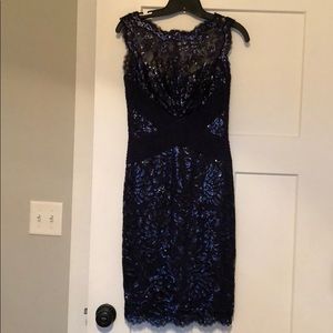 Navy blue sleeveless lace dress.
